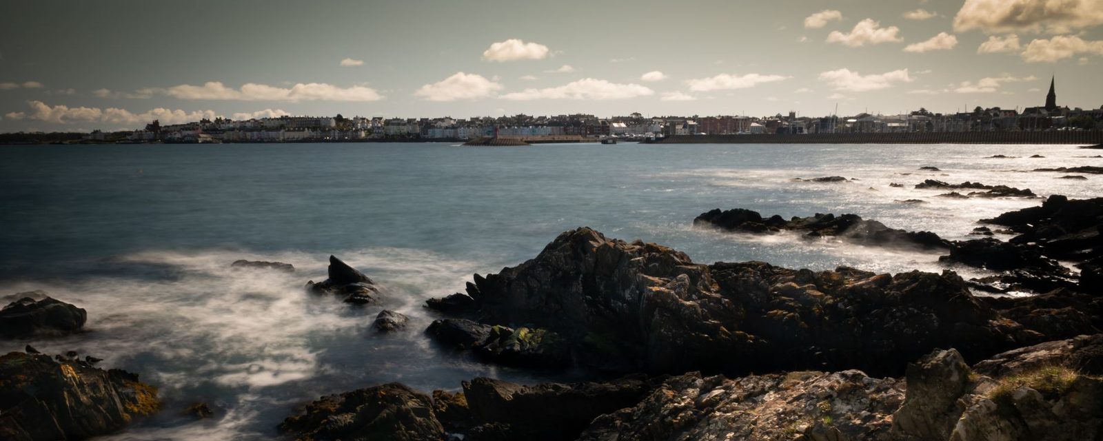 Bangor seafront and marina seen across the bay from the rocks, County Down