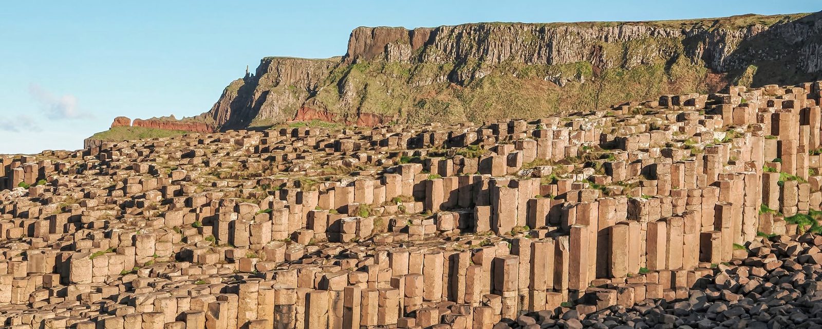The basalt columns of the Giant's Causeway against a cliff on the north Antrim coast