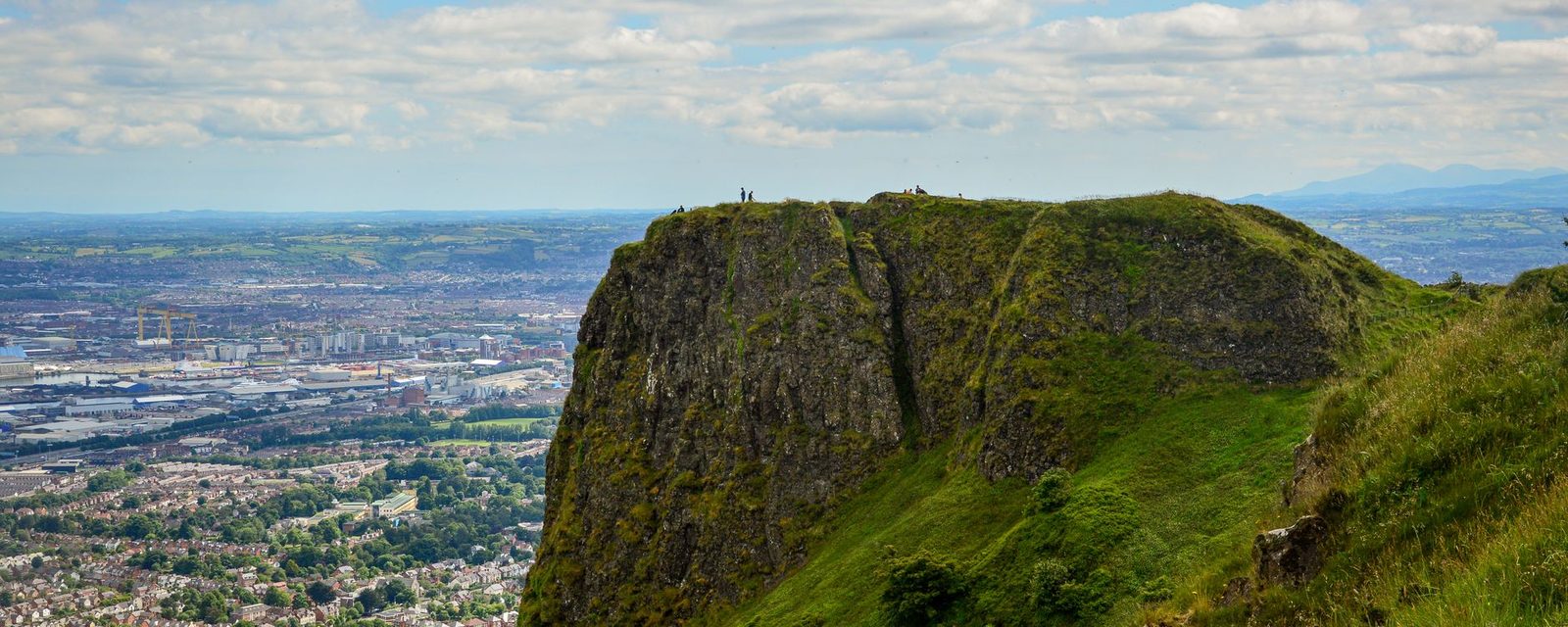 The basalt cliff of Cave Hill with Belfast and the lough spread out below